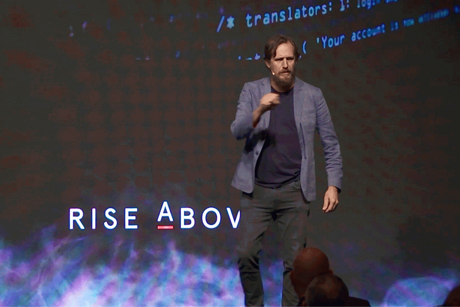 Simon Waller gestures peace sign on stage