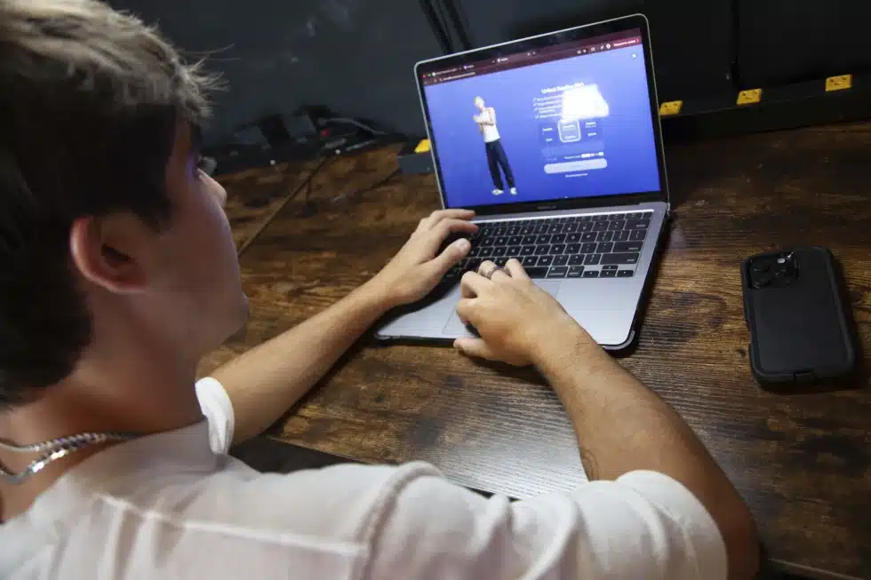 Bruce Perry, 17, demonstrates the possibilities of artificial intelligence by creating an AI companion on Character AI, Tuesday, July 15, 2025, in Russellville, Ark. (AP Photo/Katie Adkins)